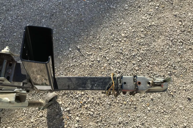 Slide: The Image of Trailer hitch of a 1997 Lowe Bass Striker 170 on gravel surface. - 14