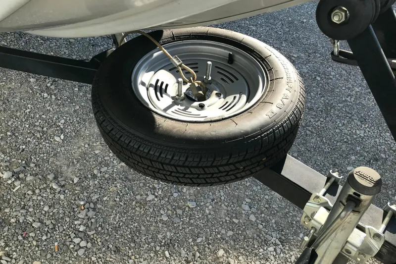 Slide: The Image of Spare tire mounted on a 1997 Lowe Bass Striker 170 boat trailer. - 15