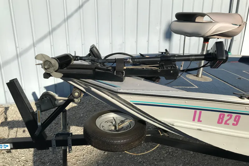 Slide: The Image of 1997 Lowe Bass Striker 170 boat on trailer, featuring trolling motor and seat. - 9