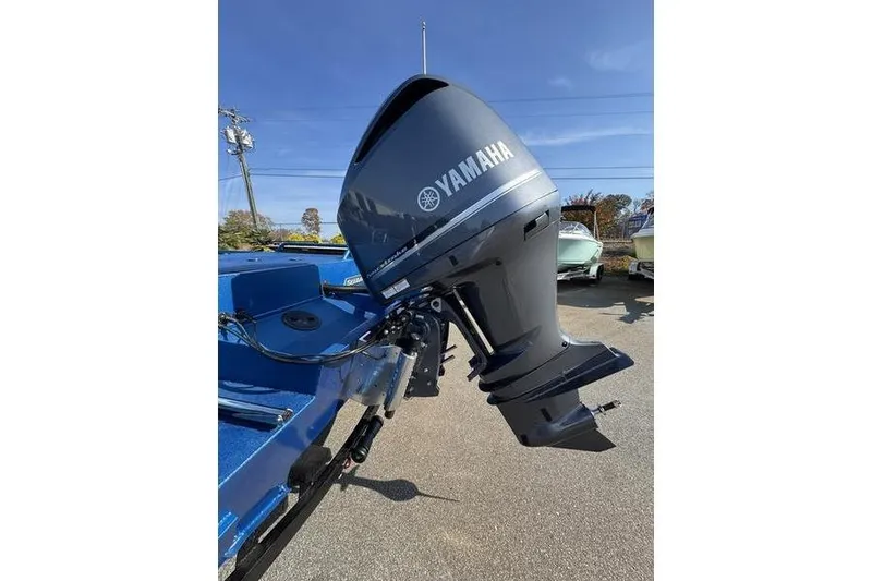Slide: The Image of 2026 SeaArk Dynasty 2.0 boat with Yamaha outboard motor, parked outdoors. - 10