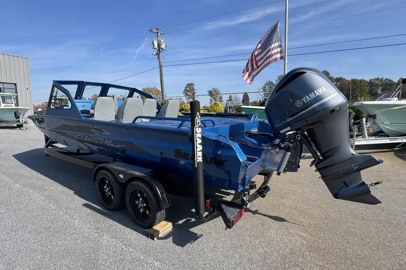 Slide: The Image of 2026 SeaArk Dynasty 2.0 boat with Yamaha motor, parked on a trailer. - 11