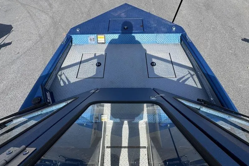 Slide: The Image of 2026 SeaArk Dynasty 2.0 boat deck with shadow, featuring blue and gray design. - 14