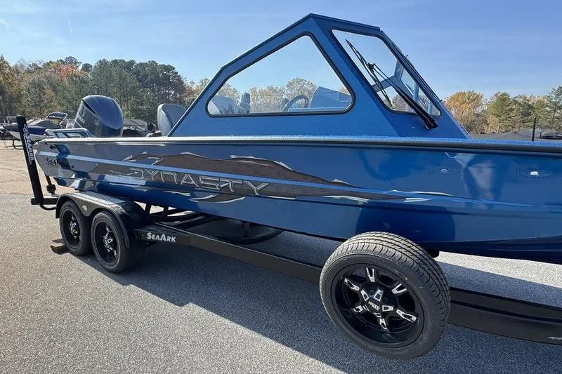 Slide: The Image of 2026 SeaArk Dynasty 2.0 boat in blue, on a trailer, outdoors. - 20