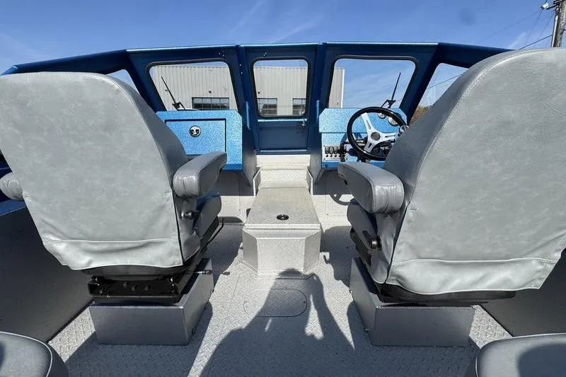 Slide: The Image of Interior of 2026 SeaArk Dynasty 2.0 boat with dual seats and steering console. - 21
