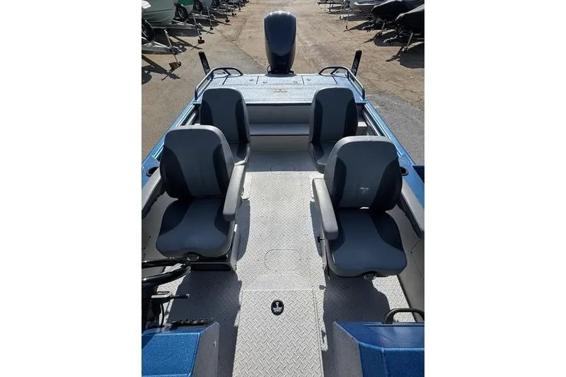 Slide: The Image of 2026 SeaArk Dynasty 2.0 boat interior with four seats and a motor. - 22