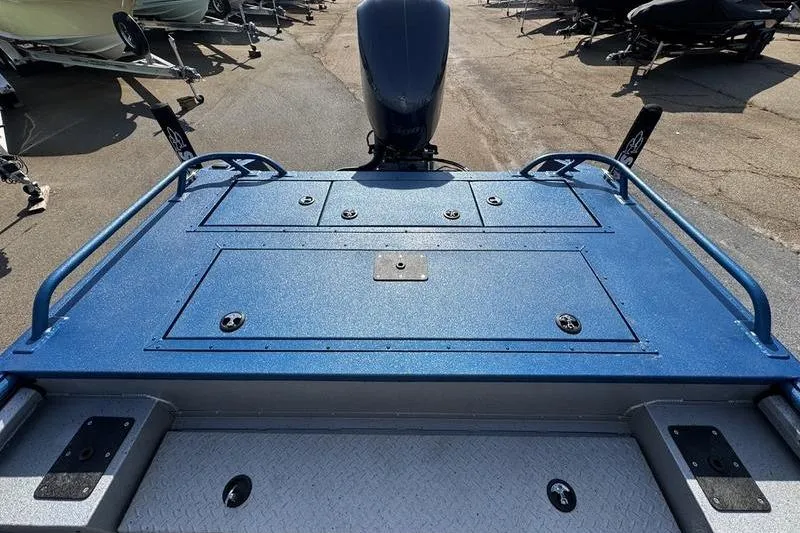 Slide: The Image of 2026 SeaArk Dynasty 2.0 boat deck with blue finish and motor view. - 27