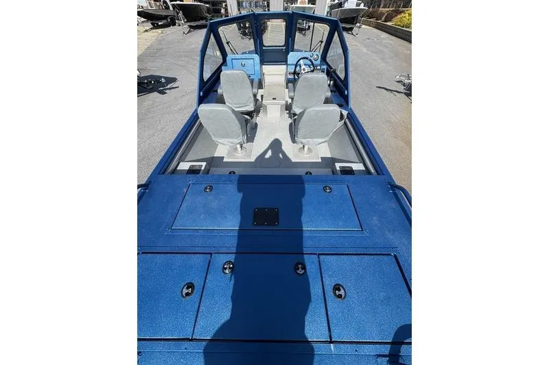 Slide: The Image of 2026 SeaArk Dynasty 2.0 boat interior with blue deck and dual seats. - 29