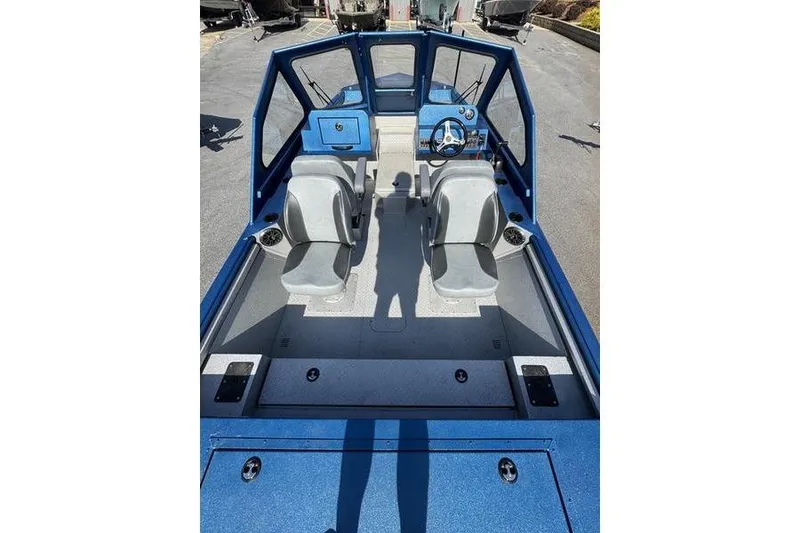 Slide: The Image of 2026 SeaArk Dynasty 2.0 boat interior with dual seats and steering console. - 31