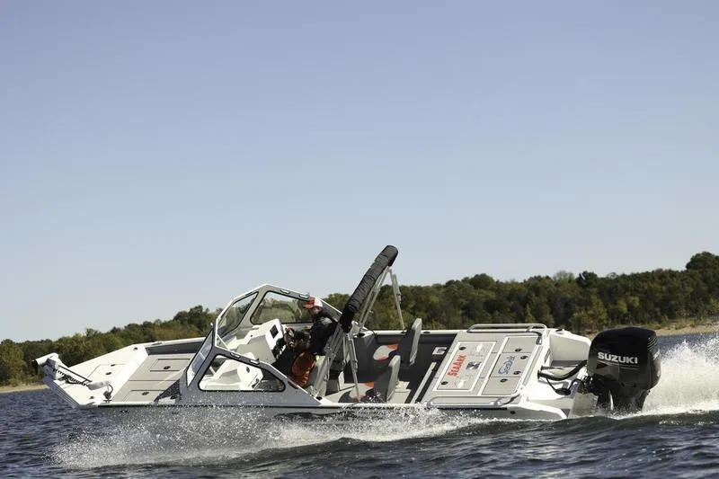 Slide: The Image of 2026 SeaArk Dynasty 2.0 boat cruising on a lake with Suzuki outboard motor. - 32