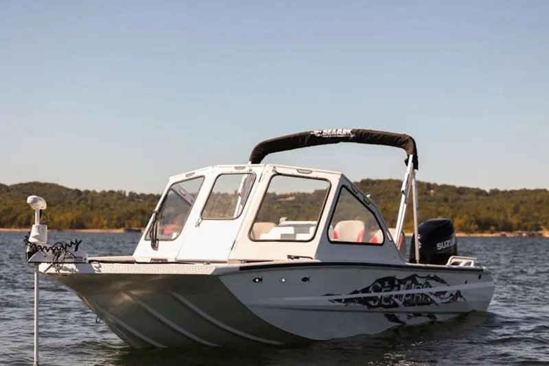 Slide: The Image of 2026 SeaArk Dynasty 2.0 boat on trailer, blue exterior, parked outdoors. - 6