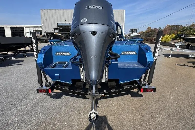 Slide: The Image of 2026 SeaArk Dynasty 2.0 boat with powerful 300 horsepower engine, parked outdoors. - 9