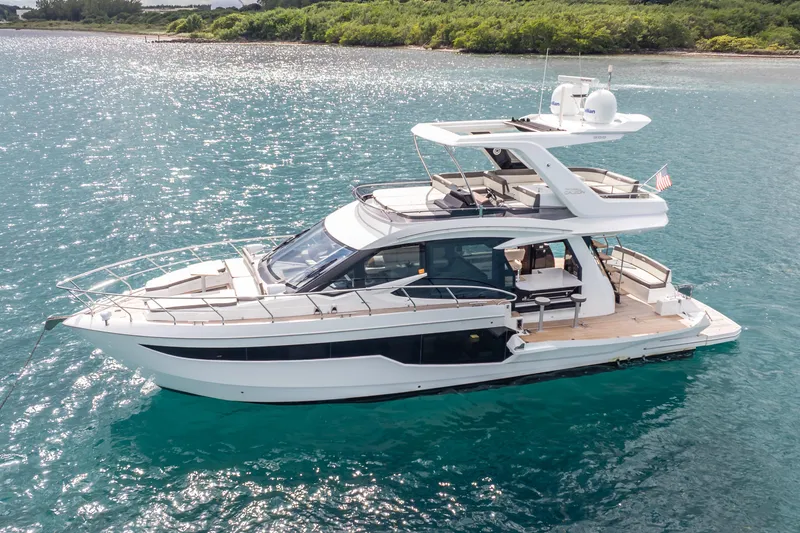 The Image of 2020 Galeon 500 Fly yacht on serene blue waters, showcasing sleek design and luxury features. - 0