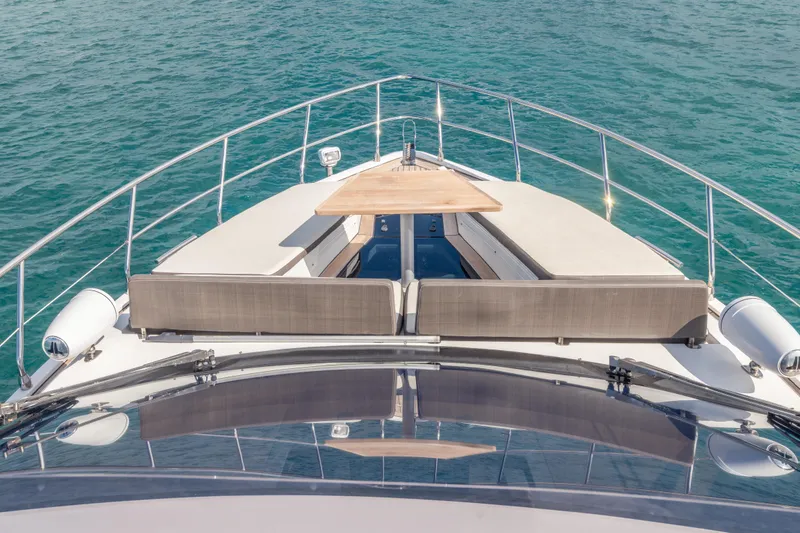 Slide: The Image of Galeon 500 Fly 2020 yacht deck with seating and table, overlooking blue ocean waters. - 16