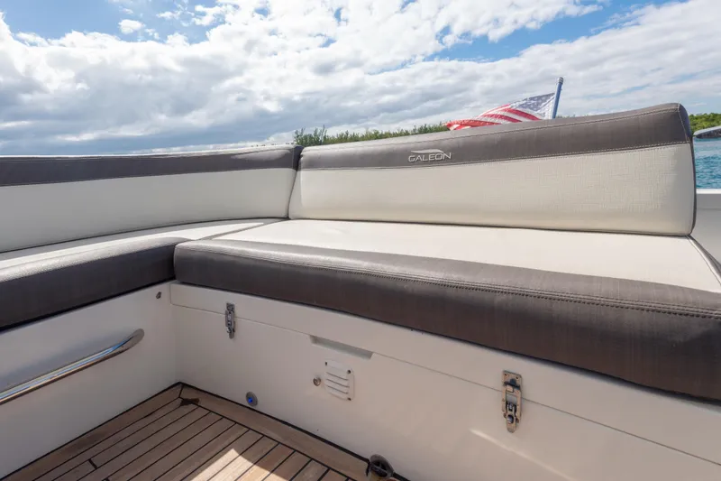 Slide: The Image of Luxury seating on 2020 Galeon 500 Fly yacht with American flag in background. - 21
