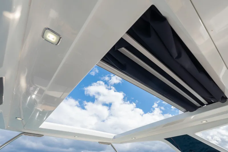 Slide: The Image of Open sunroof on 2020 Galeon 500 Fly yacht, showcasing blue sky and clouds. - 24