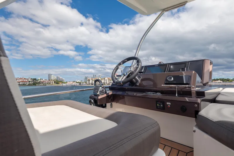 Slide: The Image of 2020 Galeon 500 Fly yacht helm with scenic waterfront view. - 26