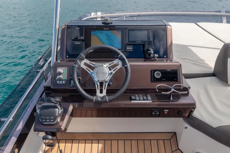 Slide: The Image of Helm of 2020 Galeon 500 Fly yacht with modern navigation equipment and steering wheel. - 27