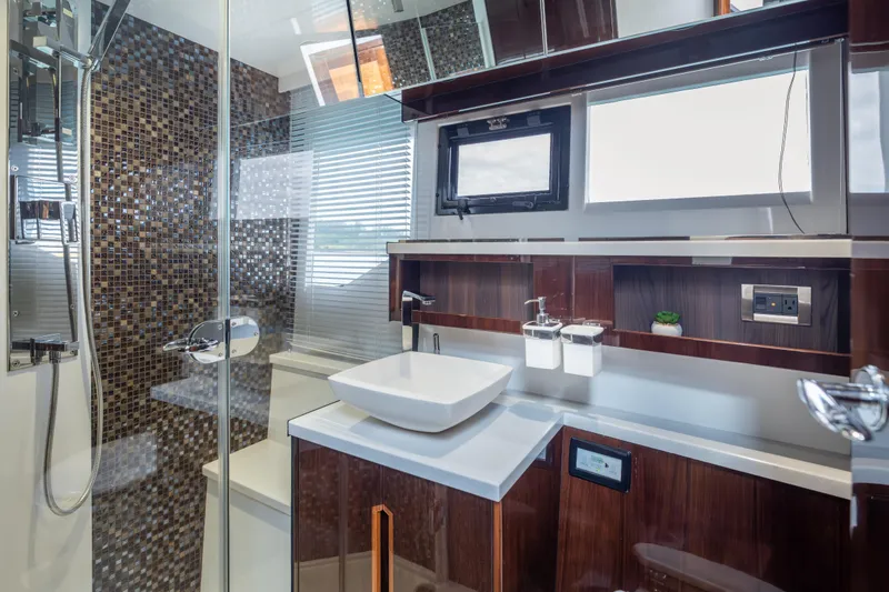Slide: The Image of Luxurious bathroom interior of 2020 Galeon 500 Fly yacht with modern fixtures and mosaic tiles. - 49
