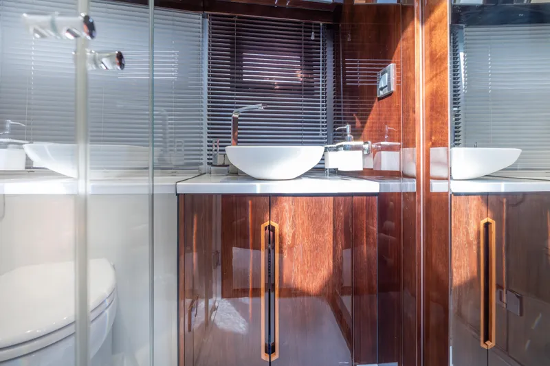 Slide: The Image of Luxurious bathroom interior on 2020 Galeon 500 Fly yacht, featuring sleek wood cabinetry and modern fixtures. - 54