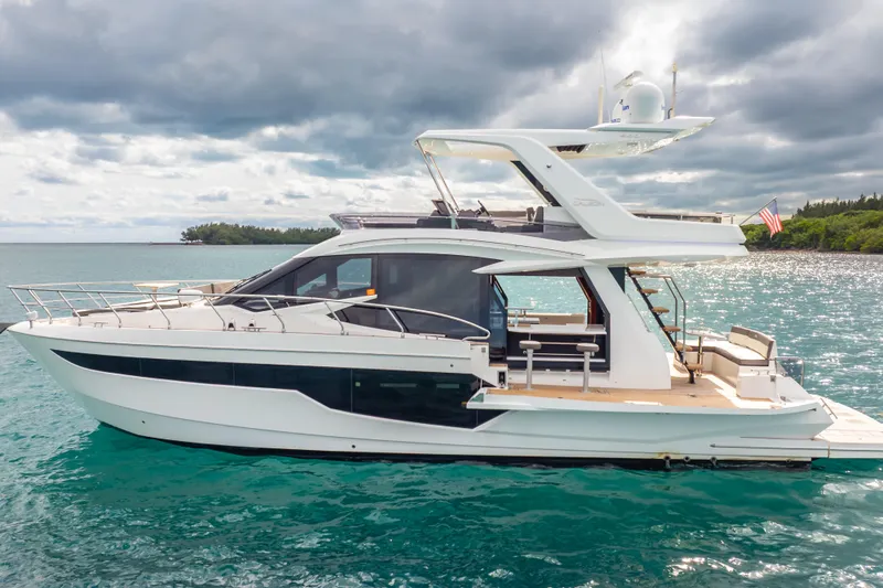 Slide: The Image of 2020 Galeon 500 Fly yacht on turquoise water under cloudy sky. - 61