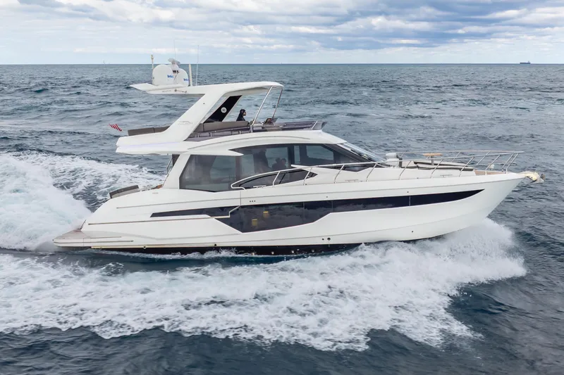 Slide: The Image of 2020 Galeon 500 Fly yacht cruising on open sea under cloudy skies. - 62
