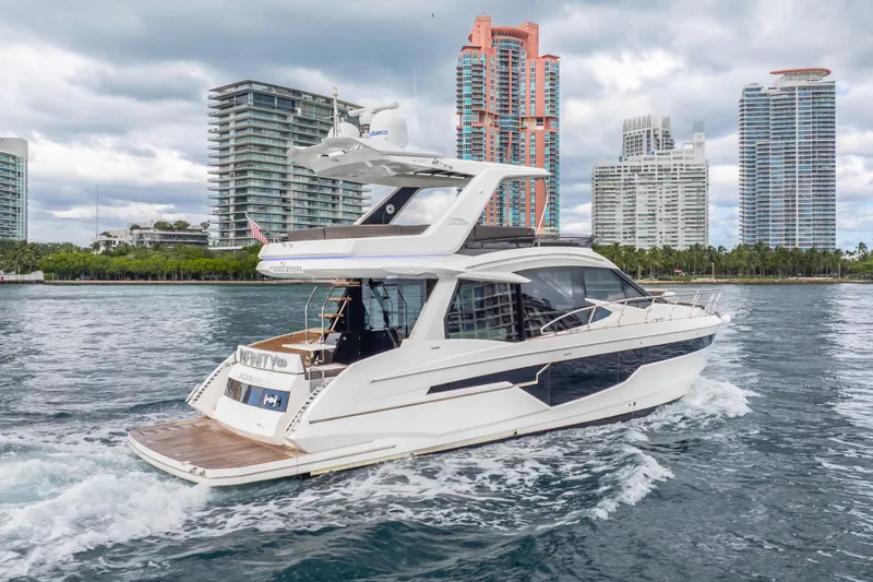 Slide: The Image of 2020 Galeon 500 Fly yacht cruising near modern city skyline. - 63