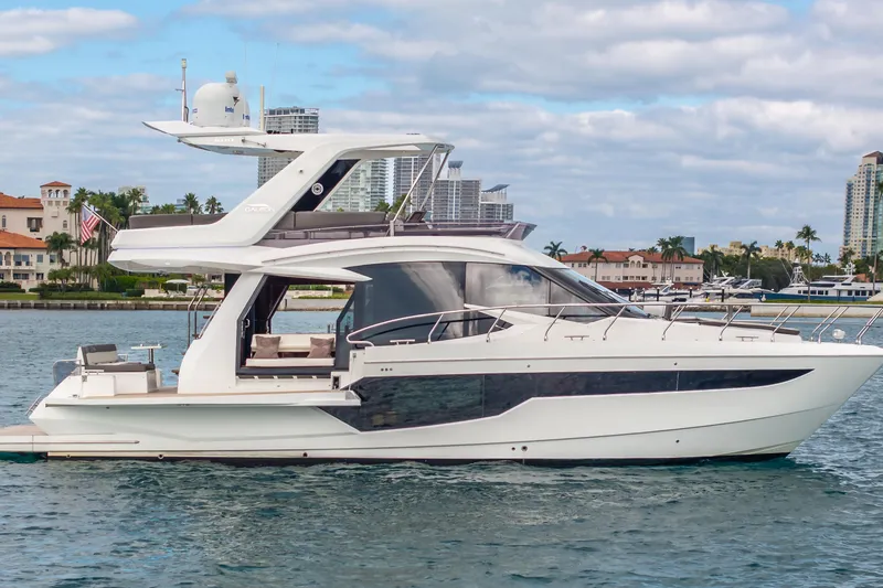 Slide: The Image of 2020 Galeon 500 Fly yacht cruising near urban waterfront skyline. - 66