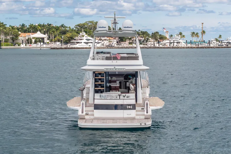 Slide: The Image of 2020 Galeon 500 Fly yacht on water, with scenic coastal backdrop. - 67