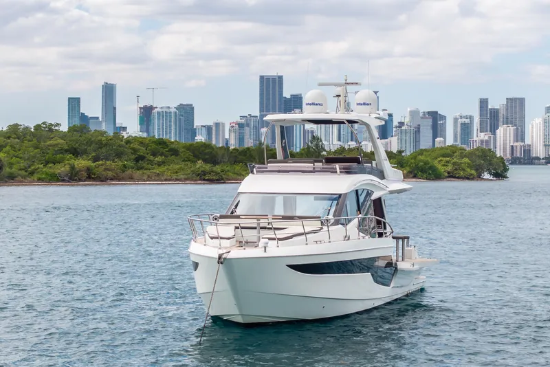 Slide: The Image of 2020 Galeon 500 Fly yacht on water with city skyline background. - 69