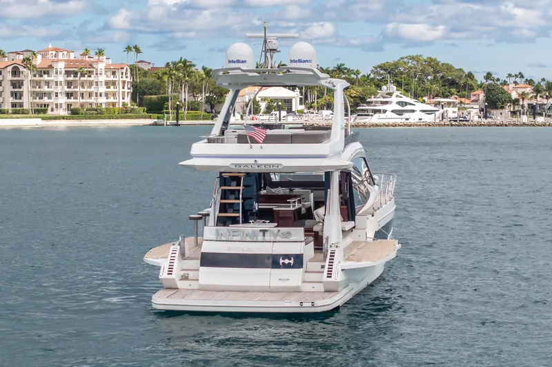 Slide: The Image of 2020 Galeon 500 Fly yacht cruising near luxury waterfront homes. - 7