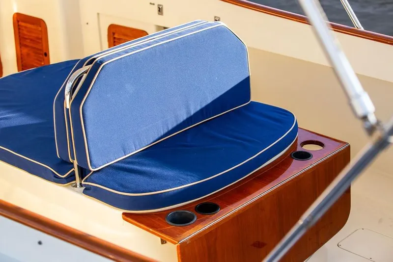 Slide: The Image of Hinckley Ya Picn 2001 boat with American flag on open water. - 18