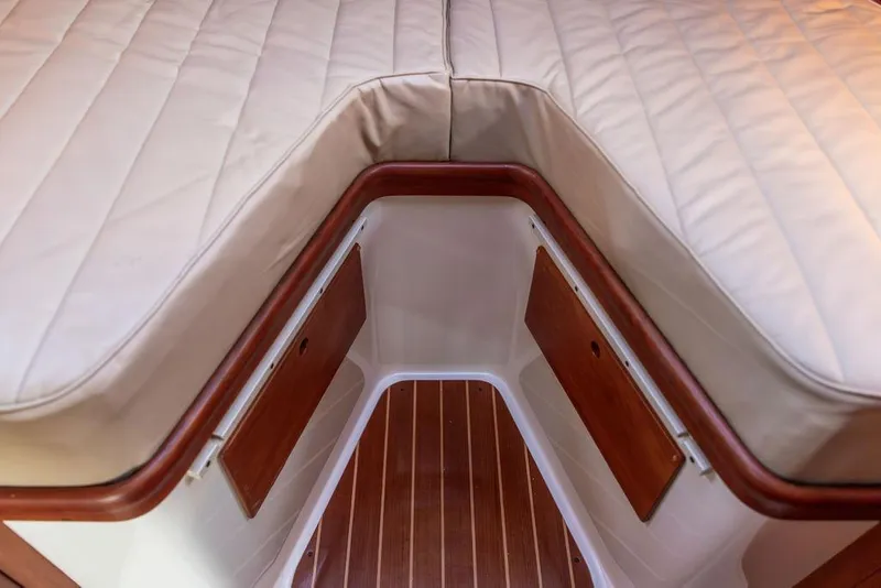 Slide: The Image of Cozy cabin interior of 2001 Hinckley Ya Picn with wooden paneling and nautical decor. - 28