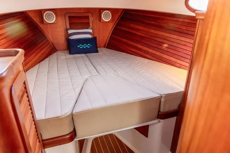 Slide: The Image of Interior of 2001 Hinckley Ya Picn boat with cozy wooden cabin and cushioned bed. - 29