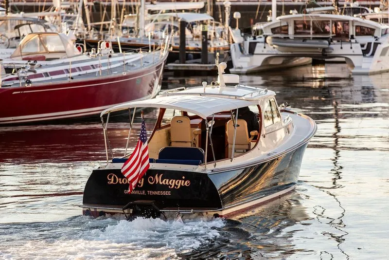 Slide: The Image of Hinckley Ya Picn 2001 boat named "Droopy Maggie" in a marina, displaying an American flag. - 38