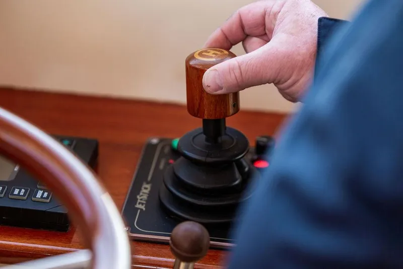 Slide: The Image of 2001 Hinckley Ya Picn boat interior with wooden accents, cruising on open water. - 9