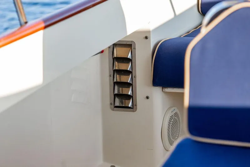 Slide: The Image of Blue cushioned seating on 2001 Hinckley Ya Picn boat with wooden accents and cup holders. - 17