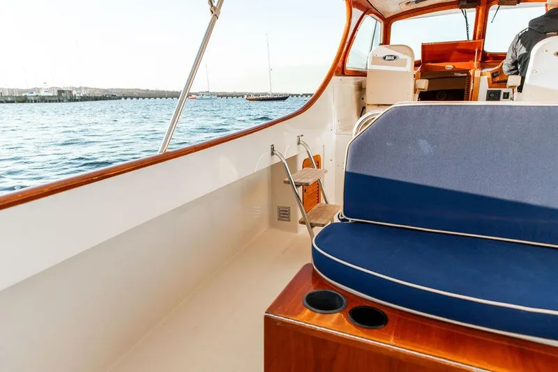 Slide: The Image of 2001 Hinckley Ya Picn yacht helm with wooden steering wheel and navigation controls. - 19