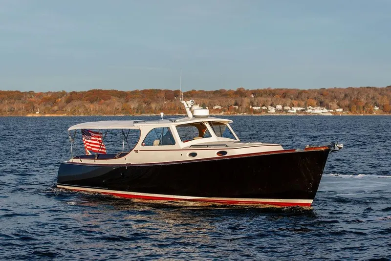 Slide: The Image of Hinckley Ya Picn 2001 yacht kitchen with wooden cabinetry, sink, and stove. - 22