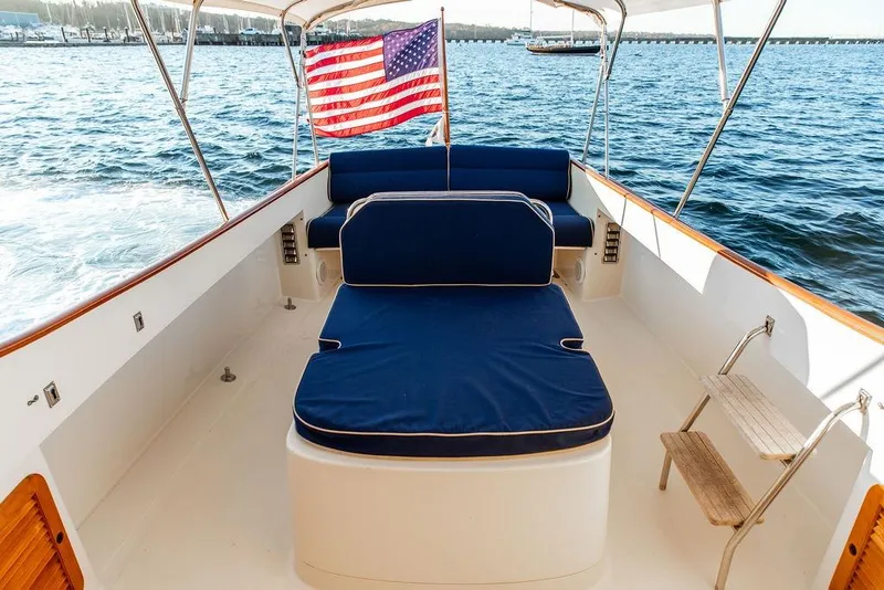 Slide: The Image of Hinckley Yachts 2000 Picnic Boat Classic cruising on a scenic lake with autumn foliage. - 3