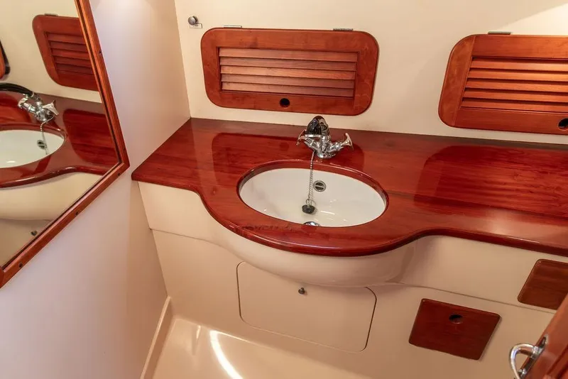 Slide: The Image of Interior of 2001 Hinckley Ya Picn boat with wooden accents and cushioned seating. - 30