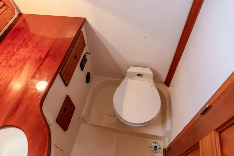 Slide: The Image of Luxurious 2001 Hinckley Ya Picn yacht bathroom with elegant wood finish and modern sink. - 31