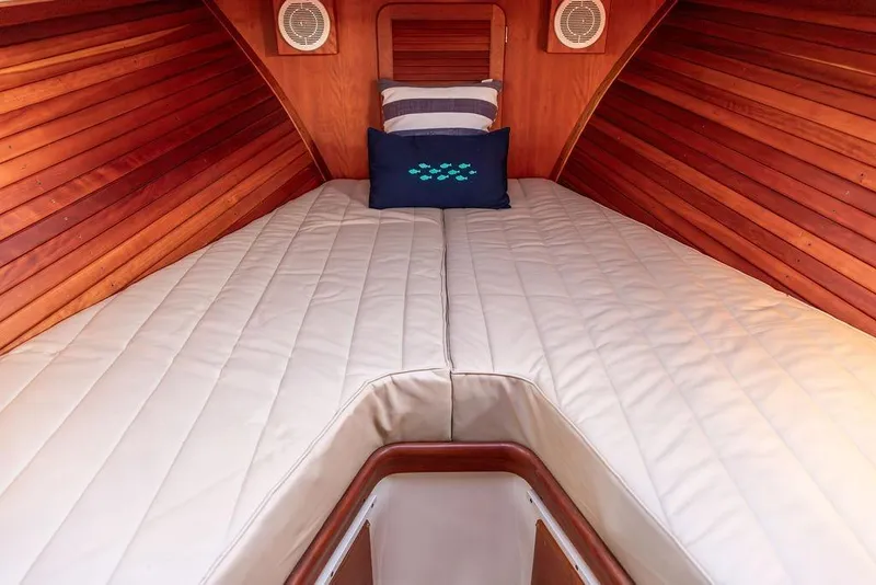 Slide: The Image of 2000 Hinckley Picnic Boat Classic cruising on a scenic lake with autumn foliage. - 4