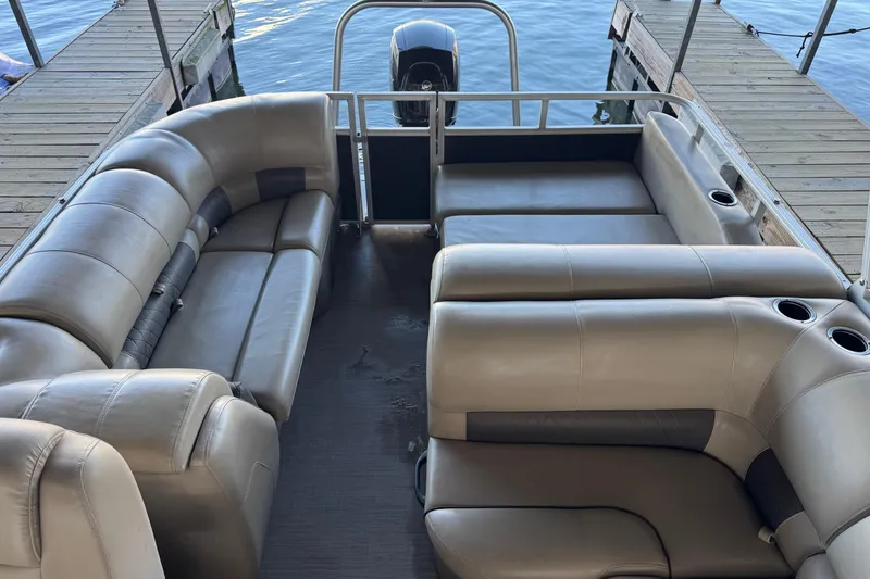 Slide: The Image of 2020 Sun Tracker Party Barge 22 DLX interior with plush seating and steering console. - 10