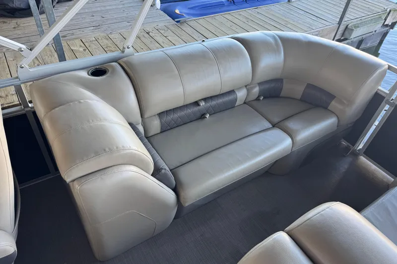 Slide: The Image of 2020 Sun Tracker Party Barge 22 DLX interior with comfortable seating and cup holders. - 13