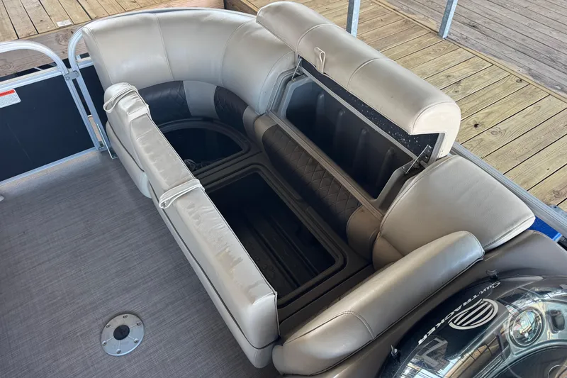 Slide: The Image of 2020 Sun Tracker Party Barge 22 DLX interior with open storage compartments. - 15
