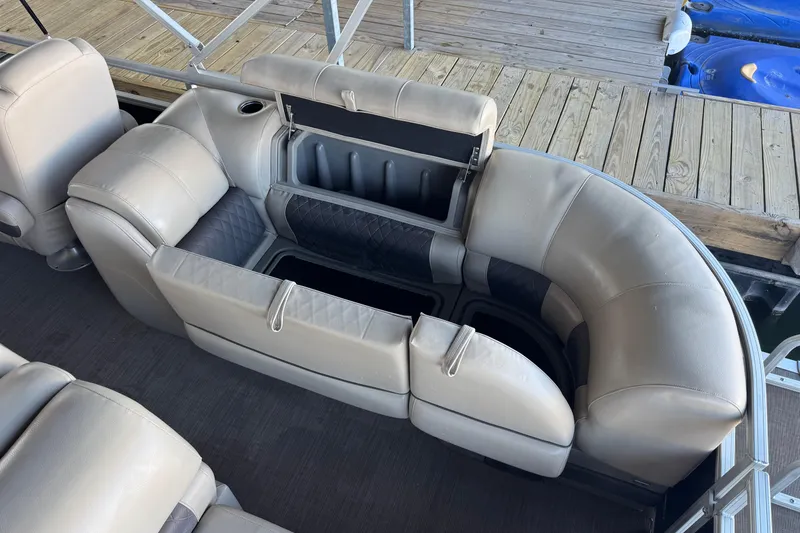 Slide: The Image of 2020 Sun Tracker Party Barge 22 DLX with open storage compartments and visible battery. - 17