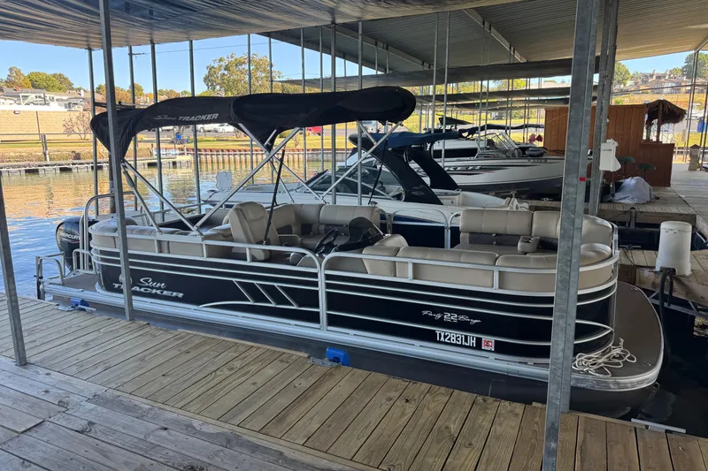 Slide: The Image of 2020 Sun Tracker Party Barge 22 DLX pontoon boat docked at marina. - 2