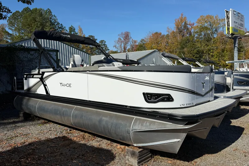 The Image of 2026 Tahoe Pontoon LTZ Quad Lounger, white exterior, parked outdoors, showcasing sleek design. - 0
