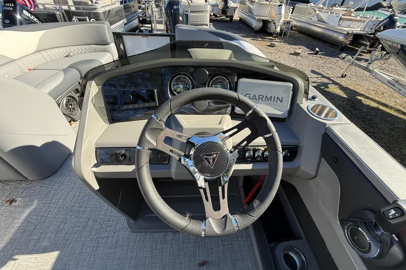 Slide: The Image of 2026 Tahoe Pontoon LTZ Quad Lounger dashboard with Garmin navigation and modern steering wheel. - 9