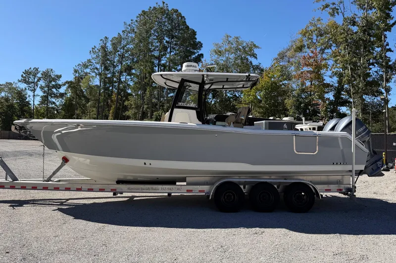 Slide: The Image of 2018 Sea Hunt Gamefish 30 Coffin Box boat on trailer, parked outdoors. - 0